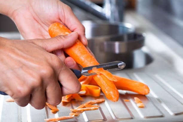 Peel the carrots. 